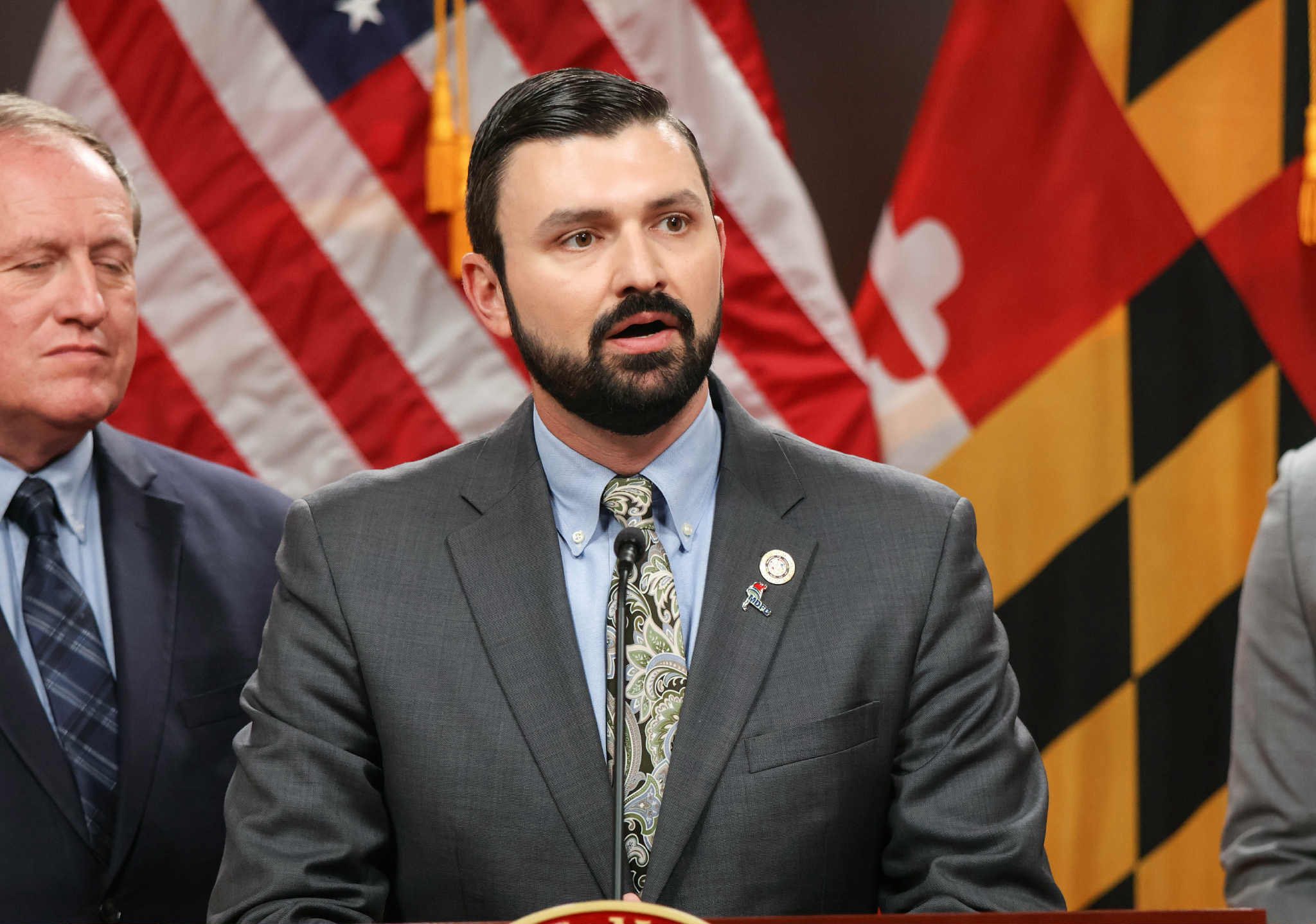 Delegate Nawrocki at a press conference with the Maryland flag