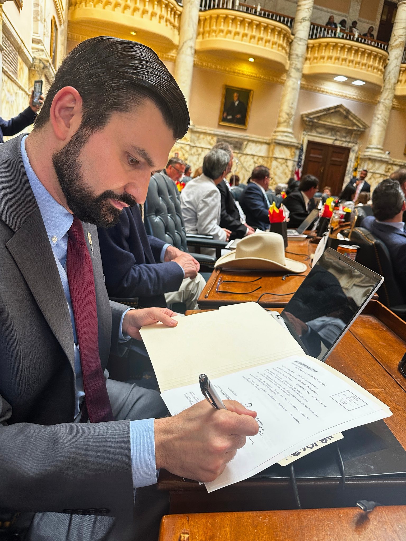 Delegate Nawrocki taking notes at his desk in the House of Delegates